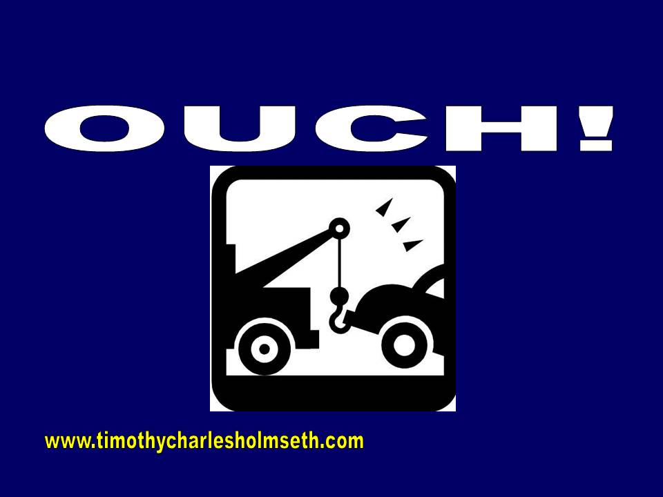 An image of a tow truck with the words ouch.