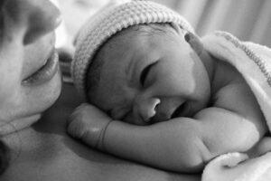 Black and white image of a lady holding her baby