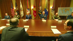 A group of military men sitting around a table.