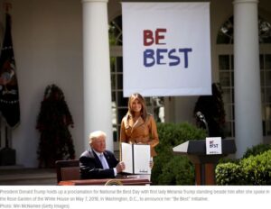 President trump and first lady melania trump sign a be best banner at the white house.