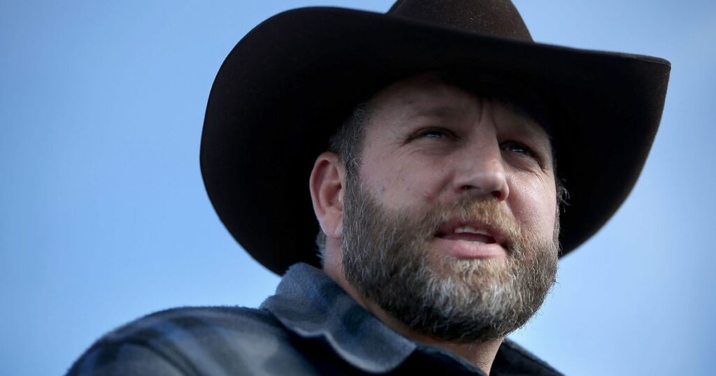 A man in a cowboy hat with a beard.