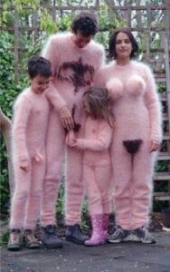 A family posing for a picture in a pink suit.