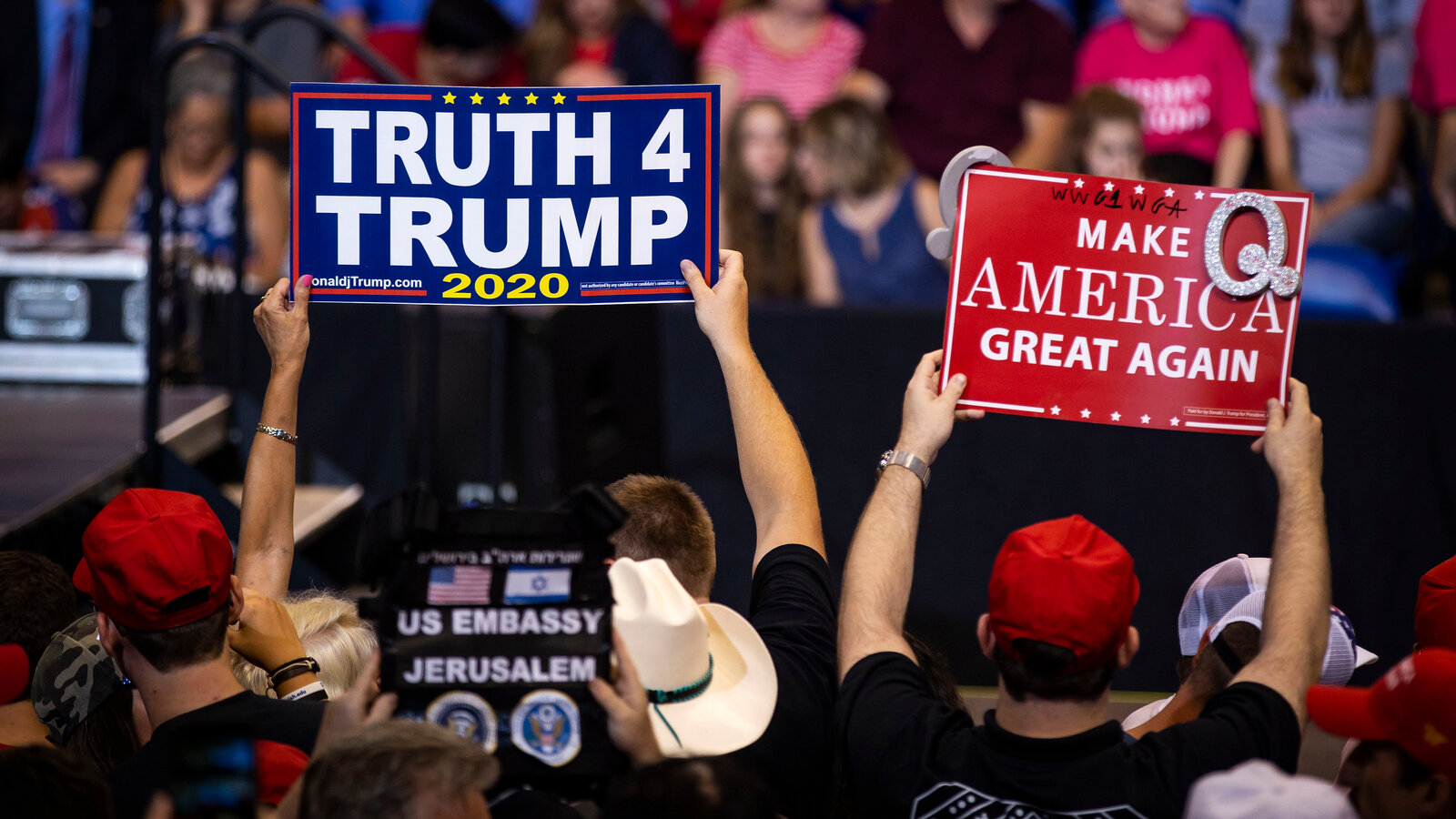 A group of people holding up signs that say truth 4 trump.