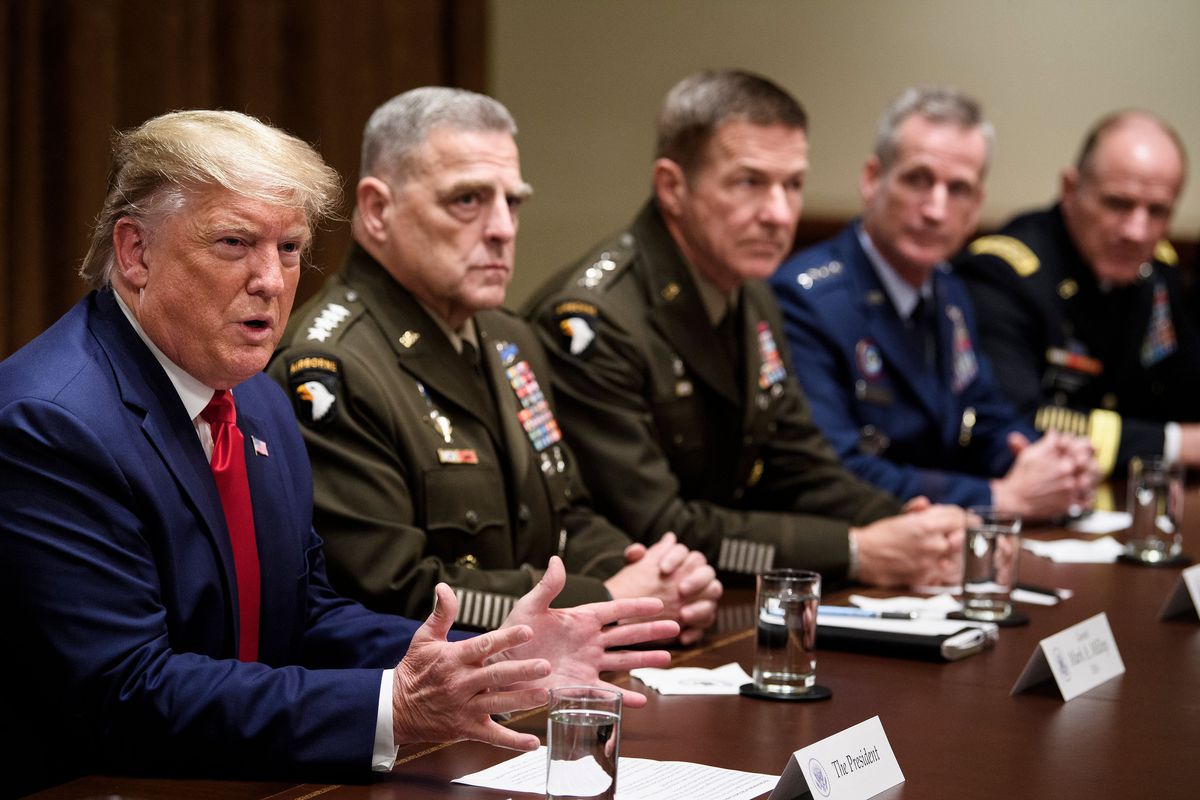 A group of military men sitting at a table.