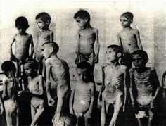An old photo of a group of naked children.
