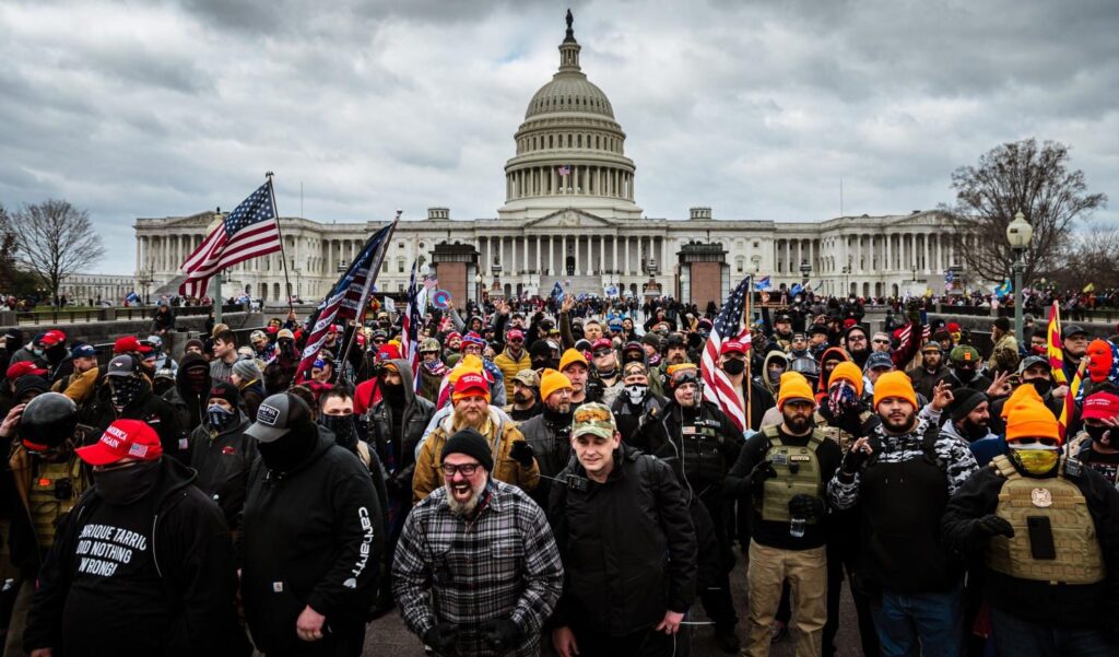 A group of people standing in front of the united states capitol.