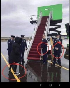 People standing outside an airplane stair