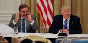 Two men are sitting at a table and giving thumbs up.