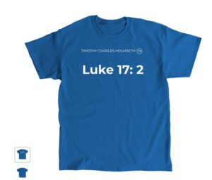 A blue shirt with a Bible verse and luke symbol
