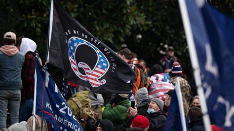 A group of people holding flags in front of a building.