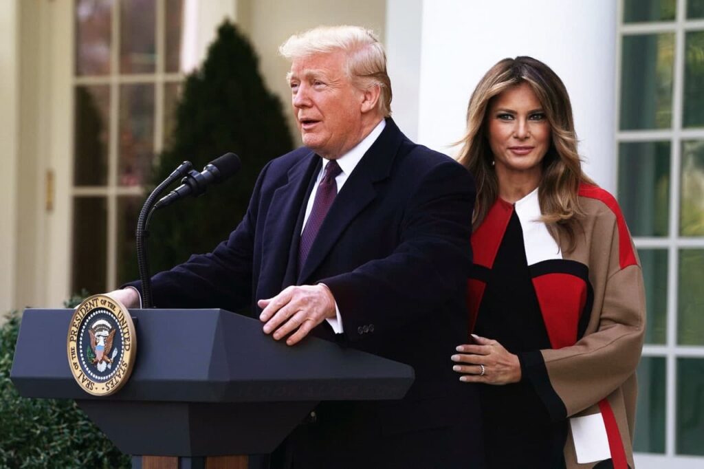 Donald trump and melania trump stand at a podium.