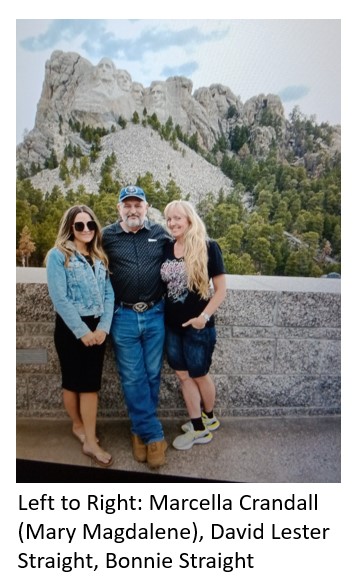 An old man standing with two girls