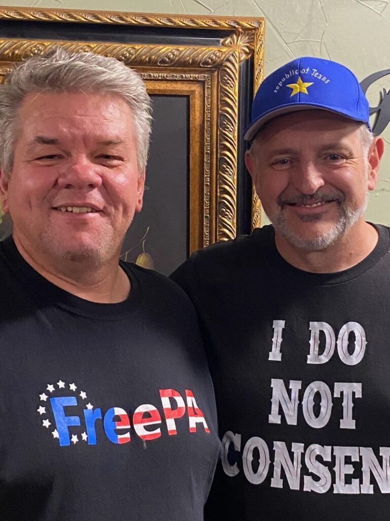 Two men wearing t-shirts that say i do not consent.