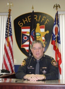 sheriff office with a man sitting down