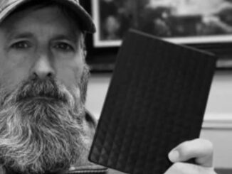 bearded man holding his hard drive