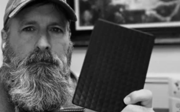 bearded man holding his hard drive
