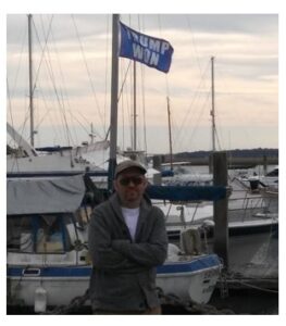 Timothy Holmseth standing near boats