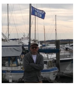 Timothy Holmseth standing near boats