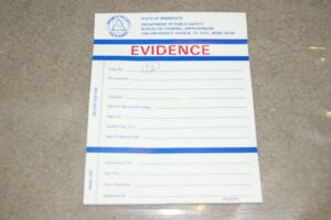 A blue and white evidence card sitting on a table.