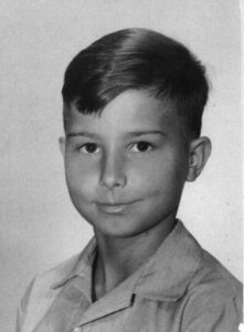 A black and white photo of a young boy.