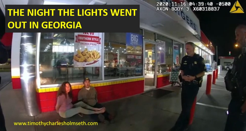 Two police officers arresting a couple on the street