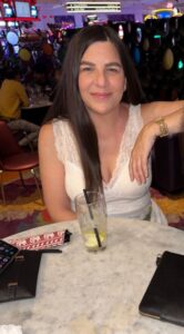 Two women sitting at a table in a casino.