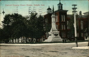 An old postcard shows a building and a statue.