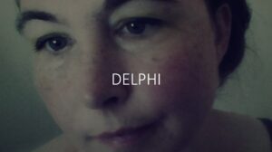 A woman's face with the word delphi written on it.