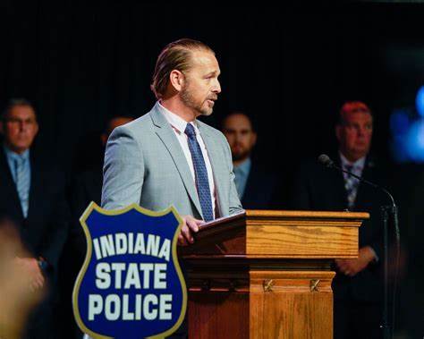 A man standing at a podium in front of a group of people.