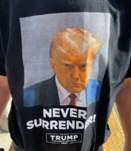 A man wearing a t-shirt that says never surrender trump.