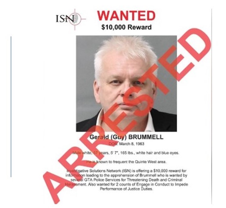 A wanted poster with an image of a man.