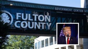 A picture of trump in front of the fulton county sign.
